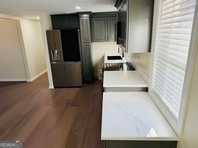 a view of a kitchen with a refrigerator