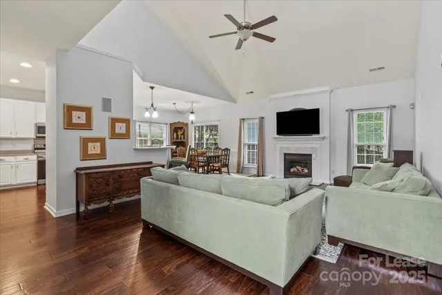 a living room with furniture a fireplace and a flat screen tv