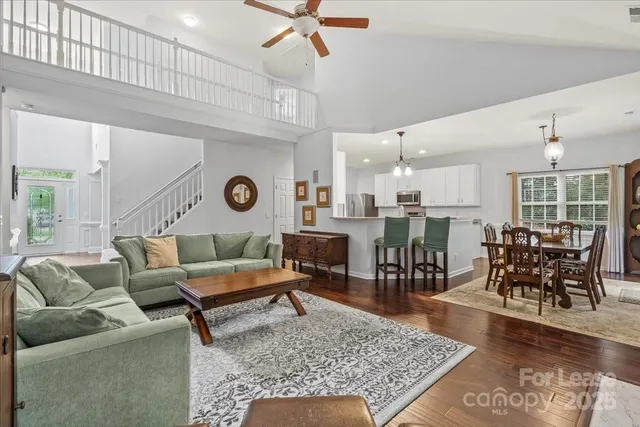 a living room with lots of furniture and view of kitchen