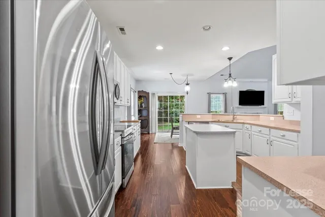 a kitchen with a sink stainless steel appliances and cabinets