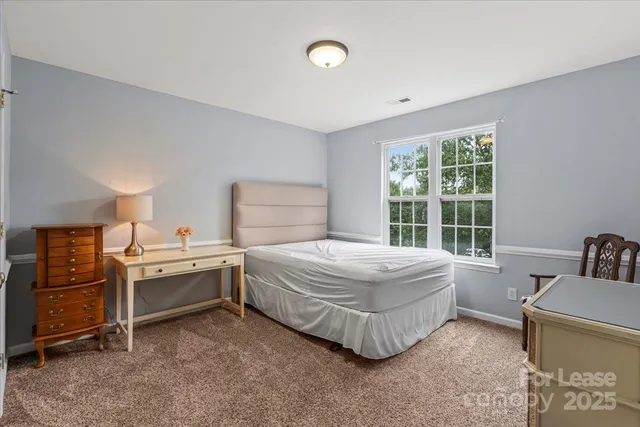 a bedroom with a bed and a sink