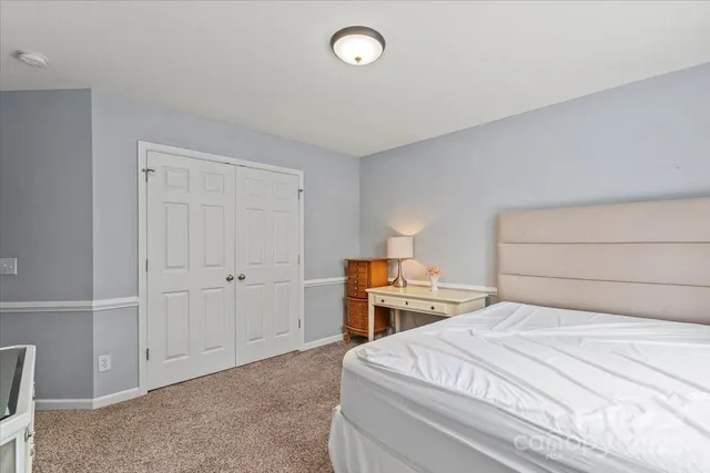 a bedroom with a bed and cabinets
