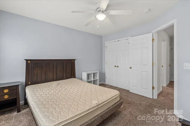 a bed sitting in a bedroom and closet