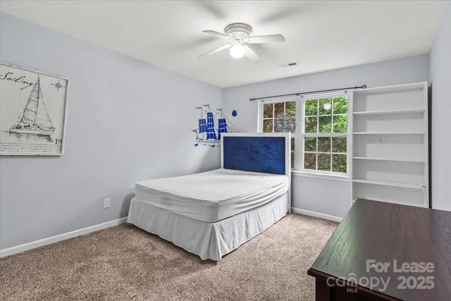 a spacious bedroom with a bed and a window