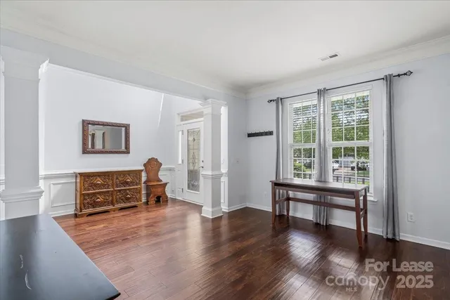 a view of a livingroom with furniture wooden floor and a window