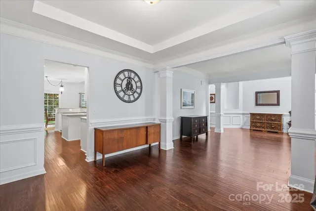 a view of living room with furniture and wooden floor