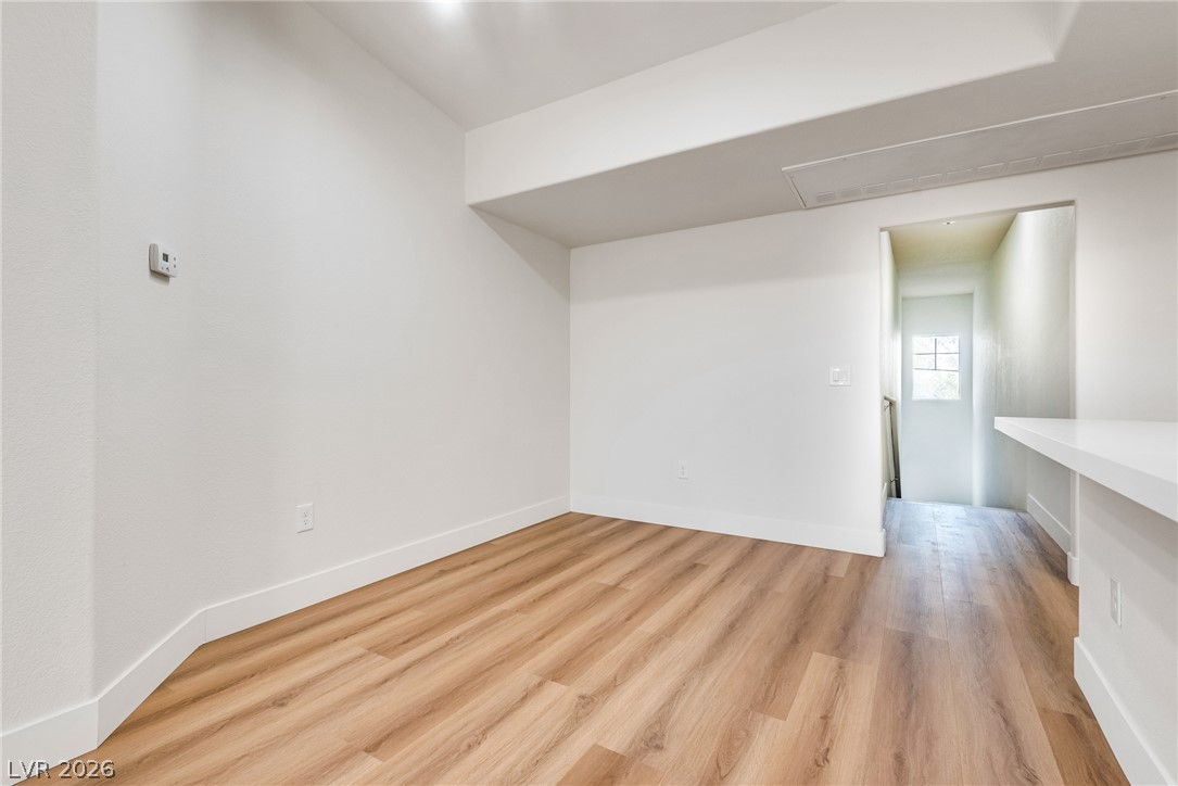 10550 West Alexander Road, Unit 2174 Las Vegas, NV 89129 - Photo 26 of 28 Gleaming wood-look floors pair beautifully with crisp white walls in this versatile bonus space.