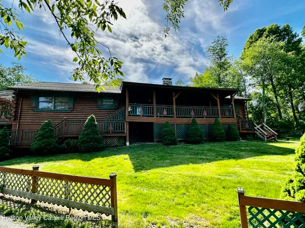 a view of house with backyard outdoor seating area and green space