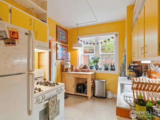 a kitchen with stove and refrigerator