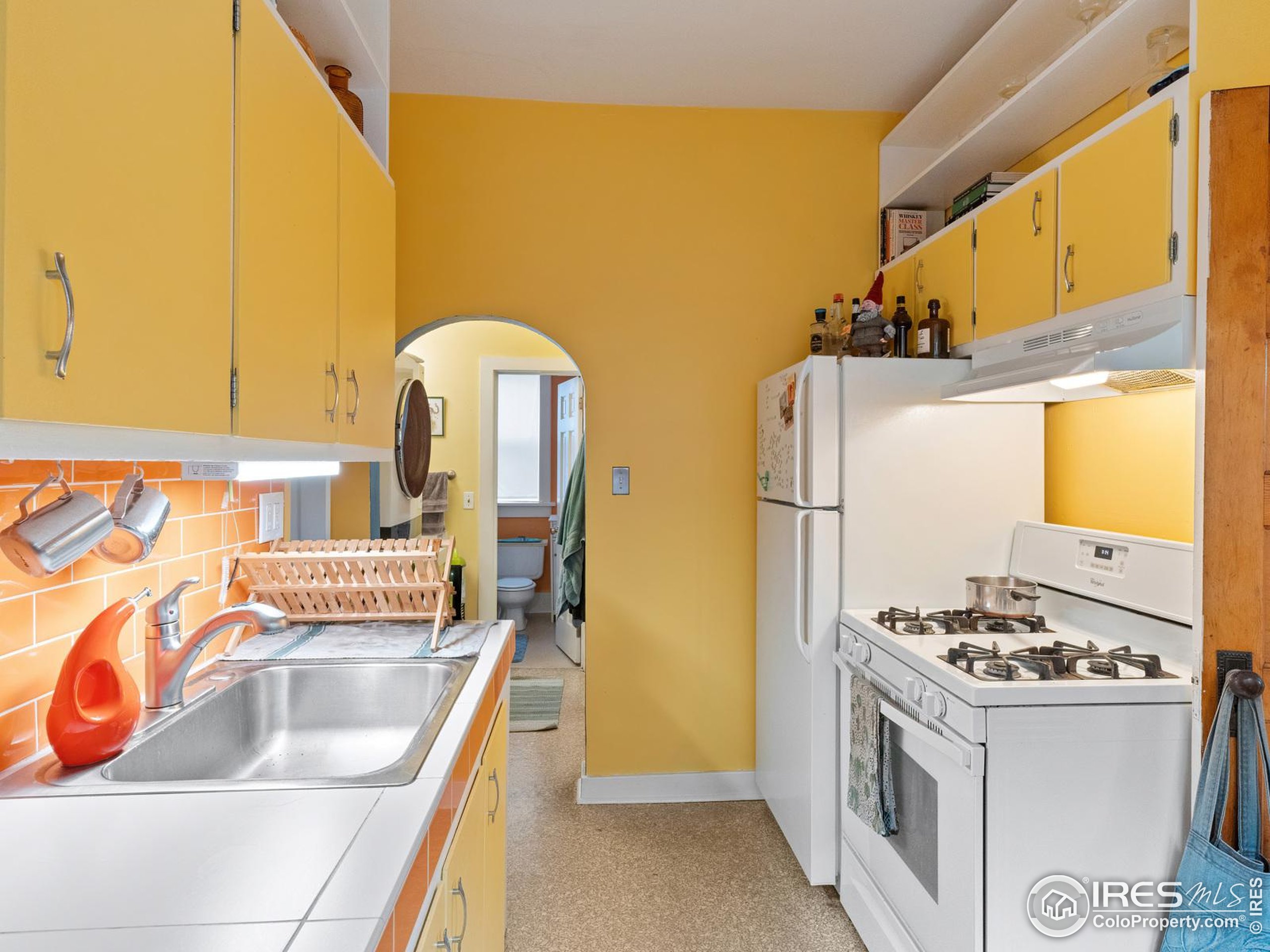 1828 Pine Street Boulder, CO 80302 - Photo 12 of 50 a kitchen with stainless steel appliances granite countertop a sink and a refrigerator