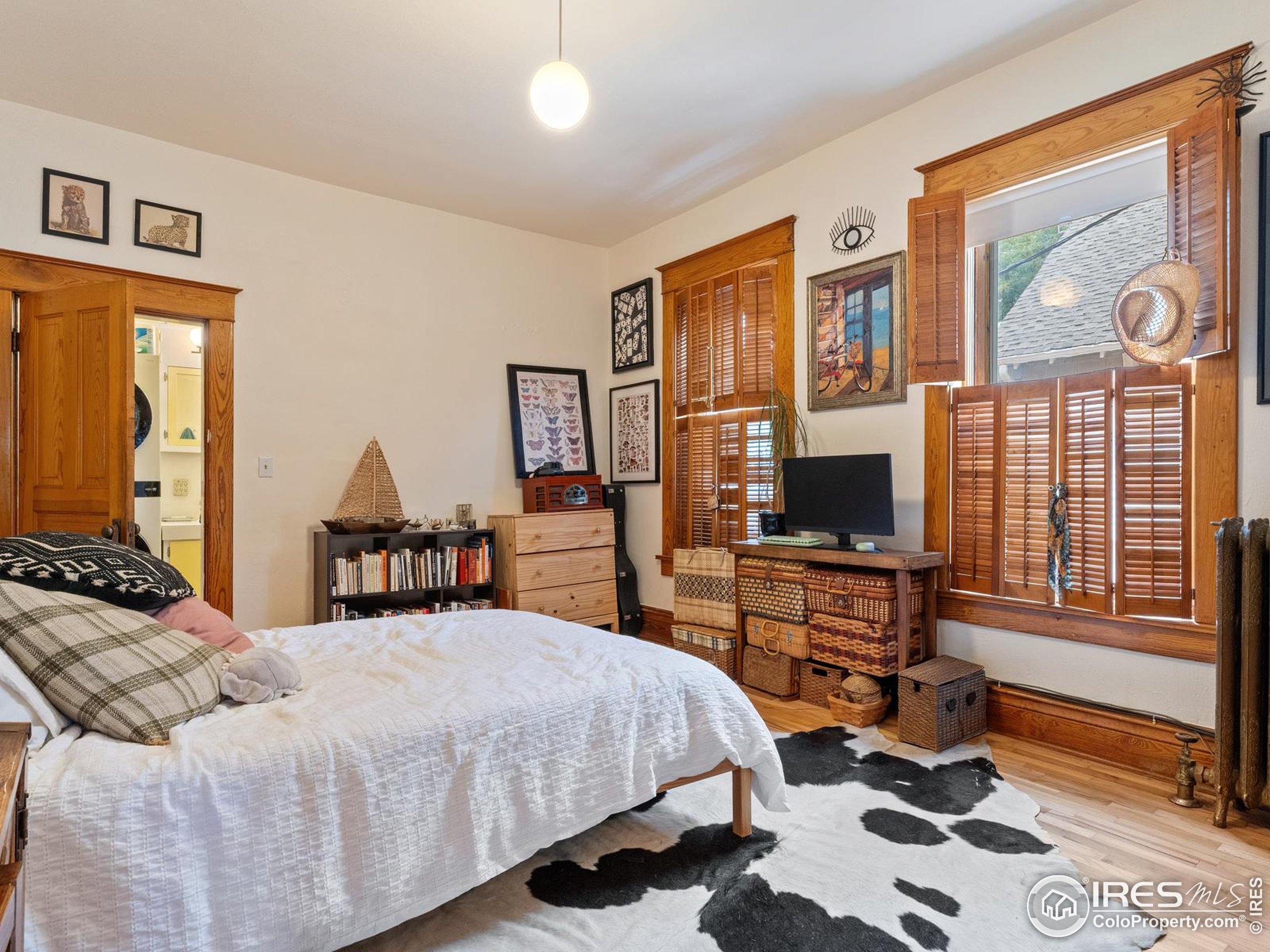 1828 Pine Street Boulder, CO 80302 - Photo 14 of 50 a bedroom with a bed and wooden floor