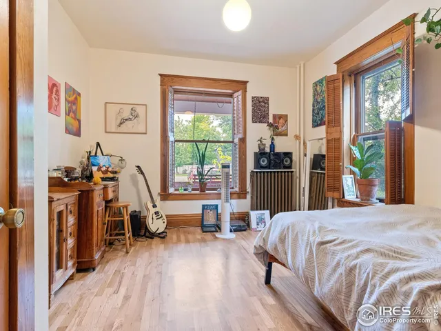 a bed room with a bed and a flat tv screen