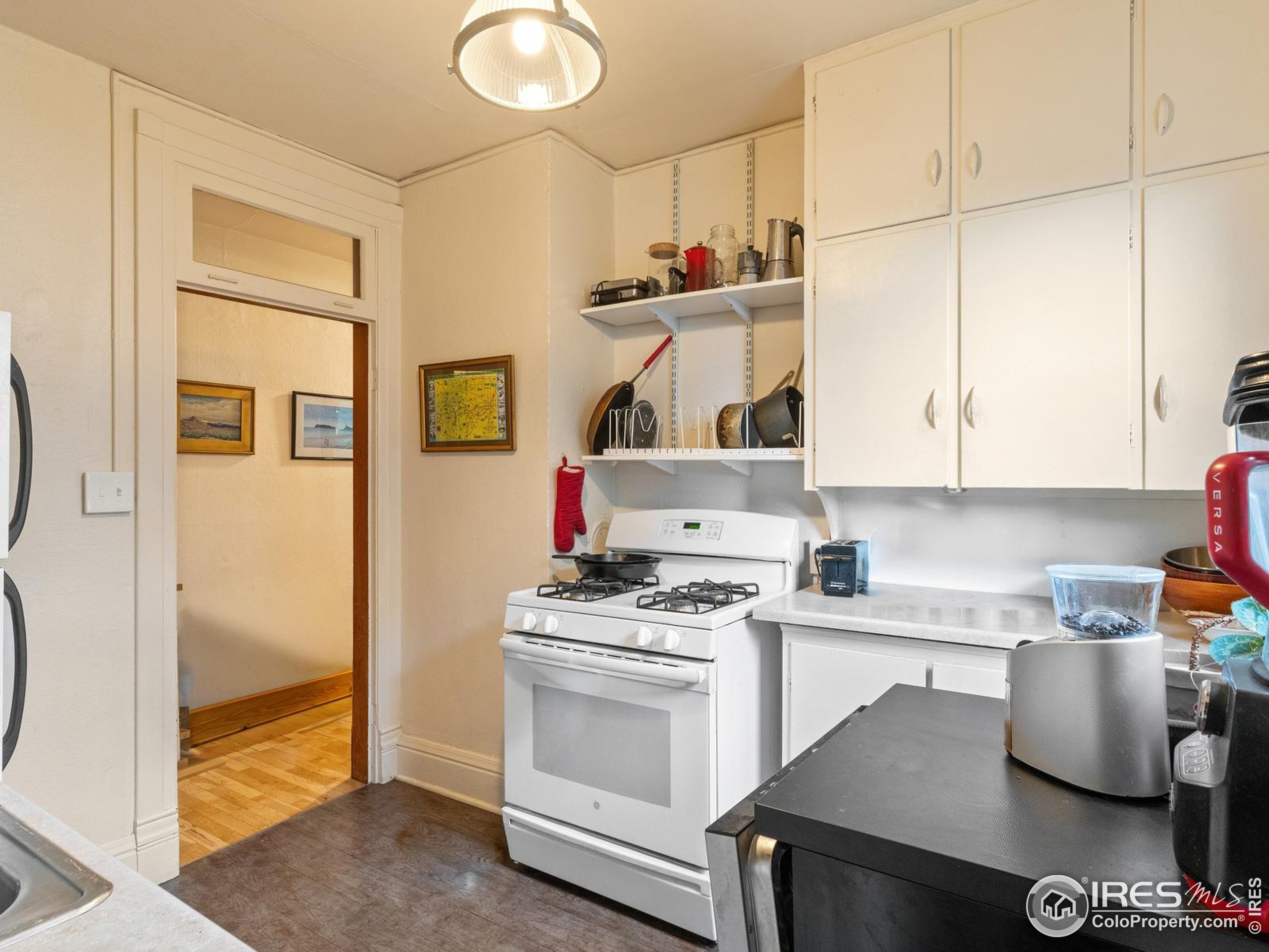 1828 Pine Street Boulder, CO 80302 - Photo 20 of 50 a kitchen with white cabinets and appliances