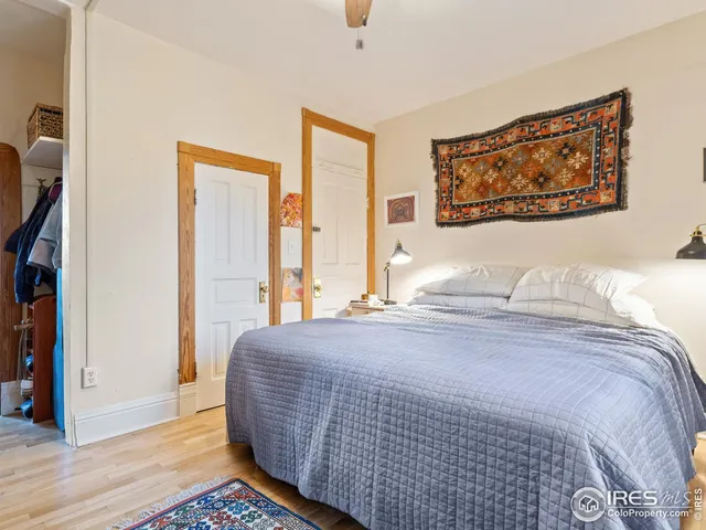 a bedroom with a bed and a painting on the wall