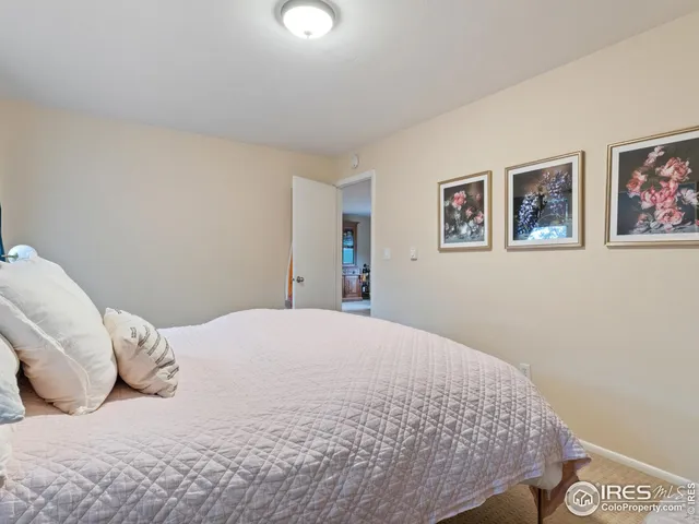 a bedroom with a bed and wall painting