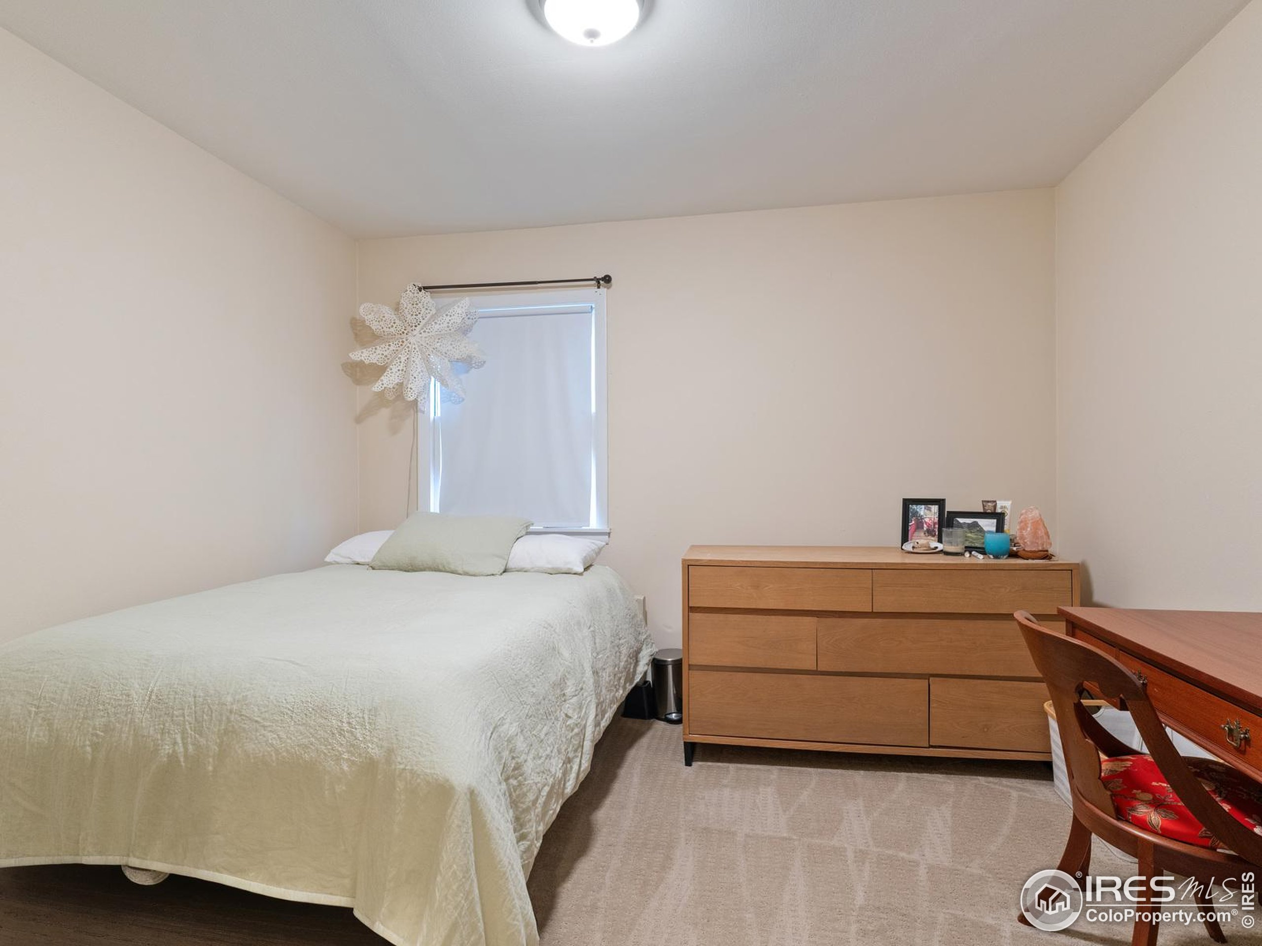 1828 Pine Street Boulder, CO 80302 - Photo 38 of 50 a bedroom with a bed and a chair