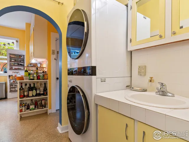 a bathroom with a sink a washer and dryer