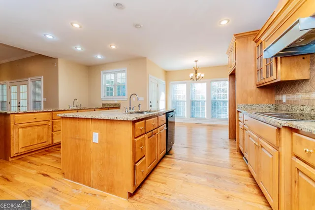a bathroom with a granite countertop sink and a window