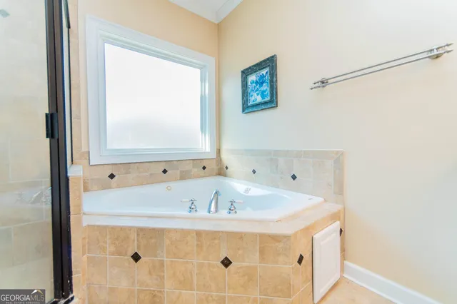 a large bathroom with a granite countertop sink and a mirror