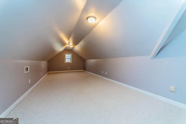 a view of a big room with closet and windows