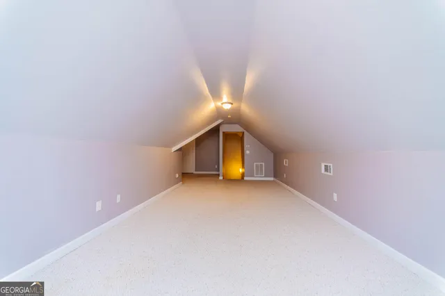 a view of an empty room with a closet