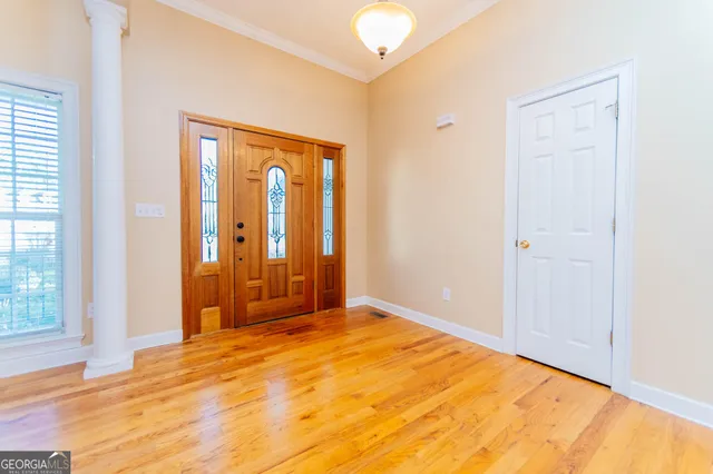a view of an empty room with floor to ceiling window and stairs