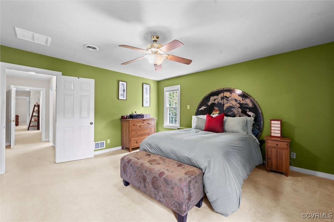12711 Foxstone Road Midlothian, VA 23113 - Photo 41 of 50 a bedroom with a bed and a chandelier