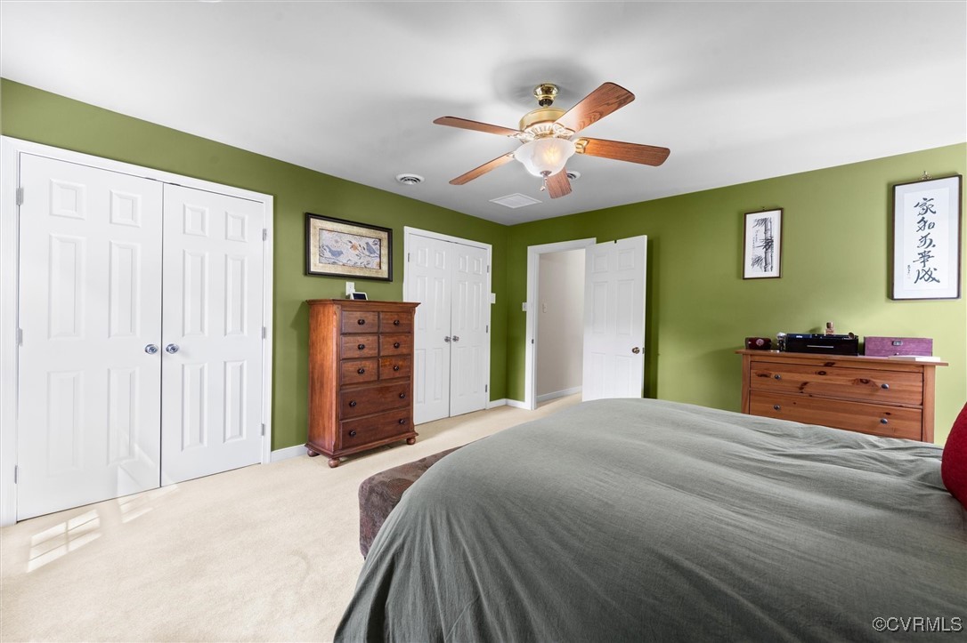 12711 Foxstone Road Midlothian, VA 23113 - Photo 42 of 50 a bedroom with a bed and a chandelier