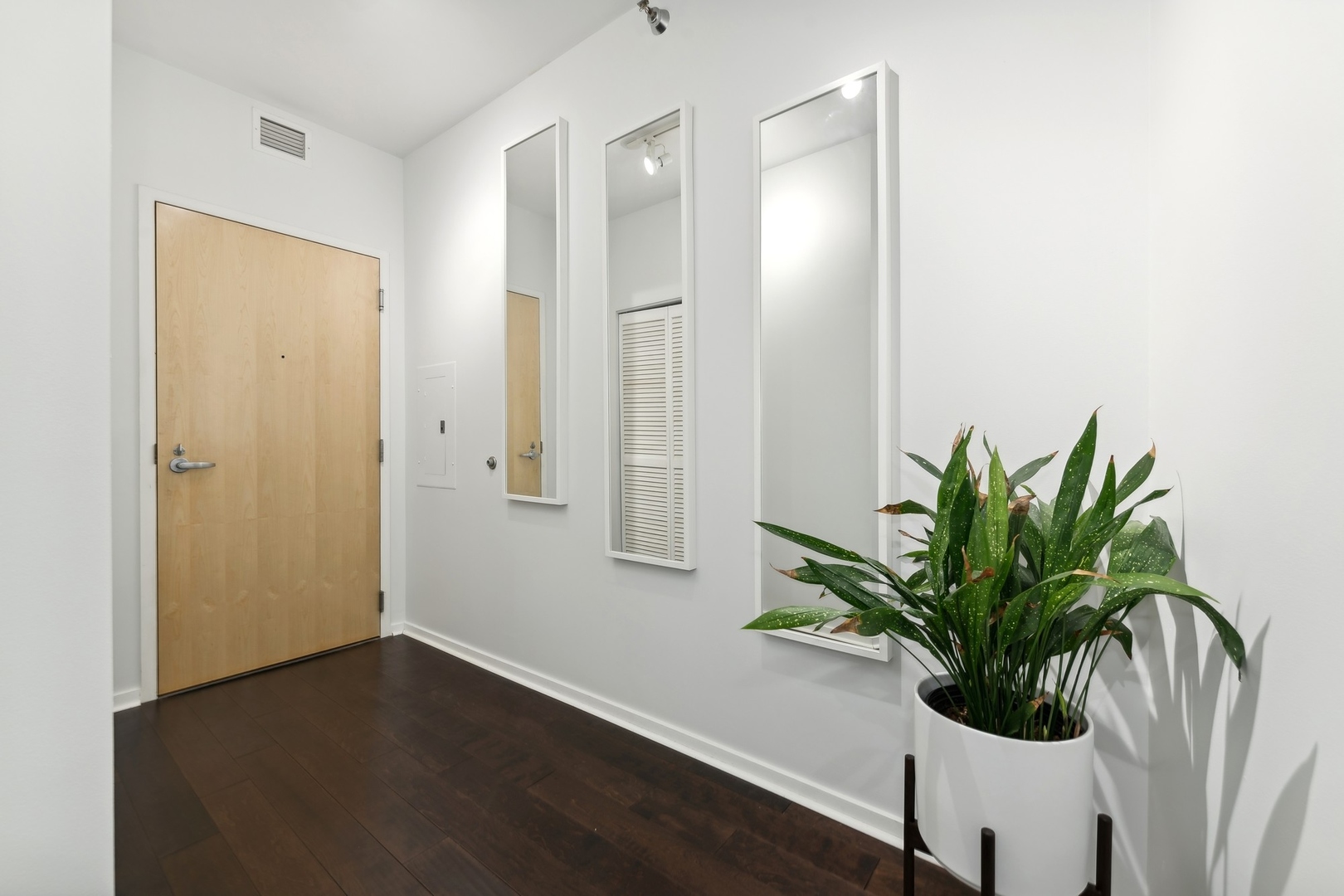 123 South Green Street, Unit 703B Chicago, IL 60607 - Photo 2 of 7 a view of a hallway with wooden floor