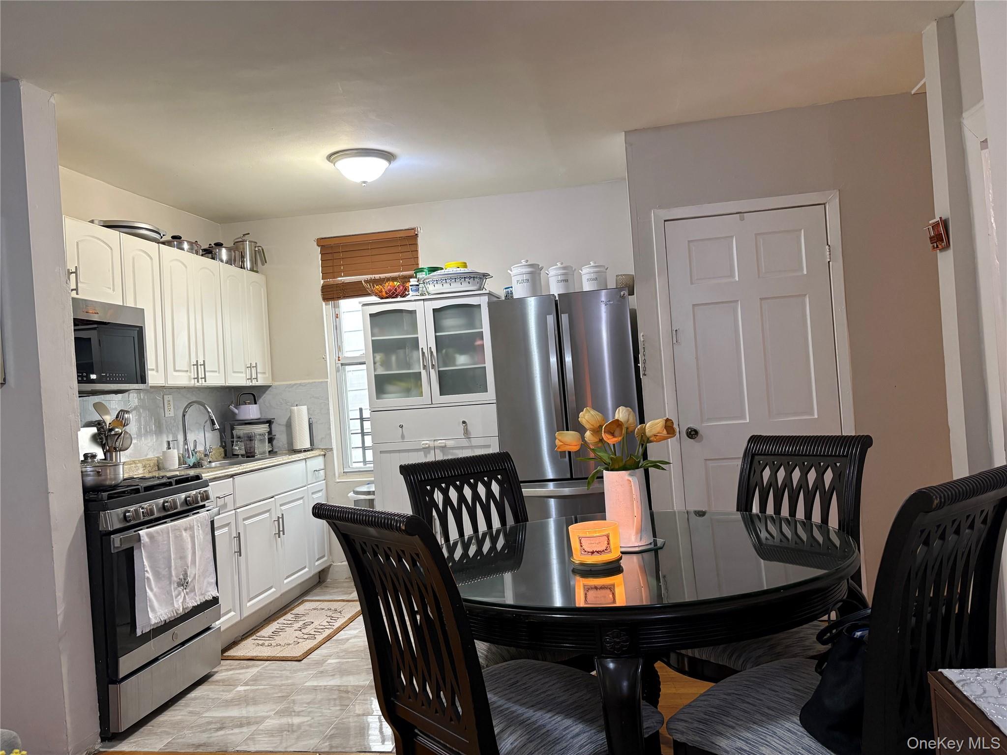 97-33 89th Street Queens, NY 11416 - Photo 5 of 13 a view of a dining room with furniture and window