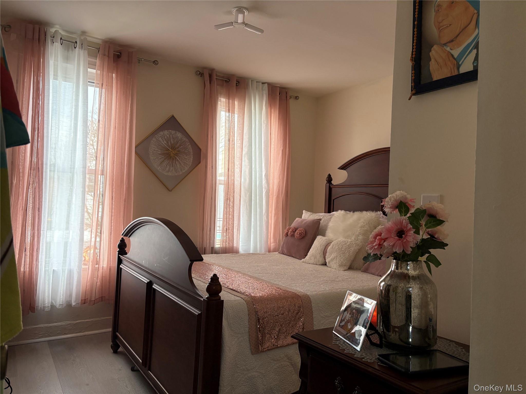 97-33 89th Street Queens, NY 11416 - Photo 9 of 13 a bedroom with a bed and a chandelier