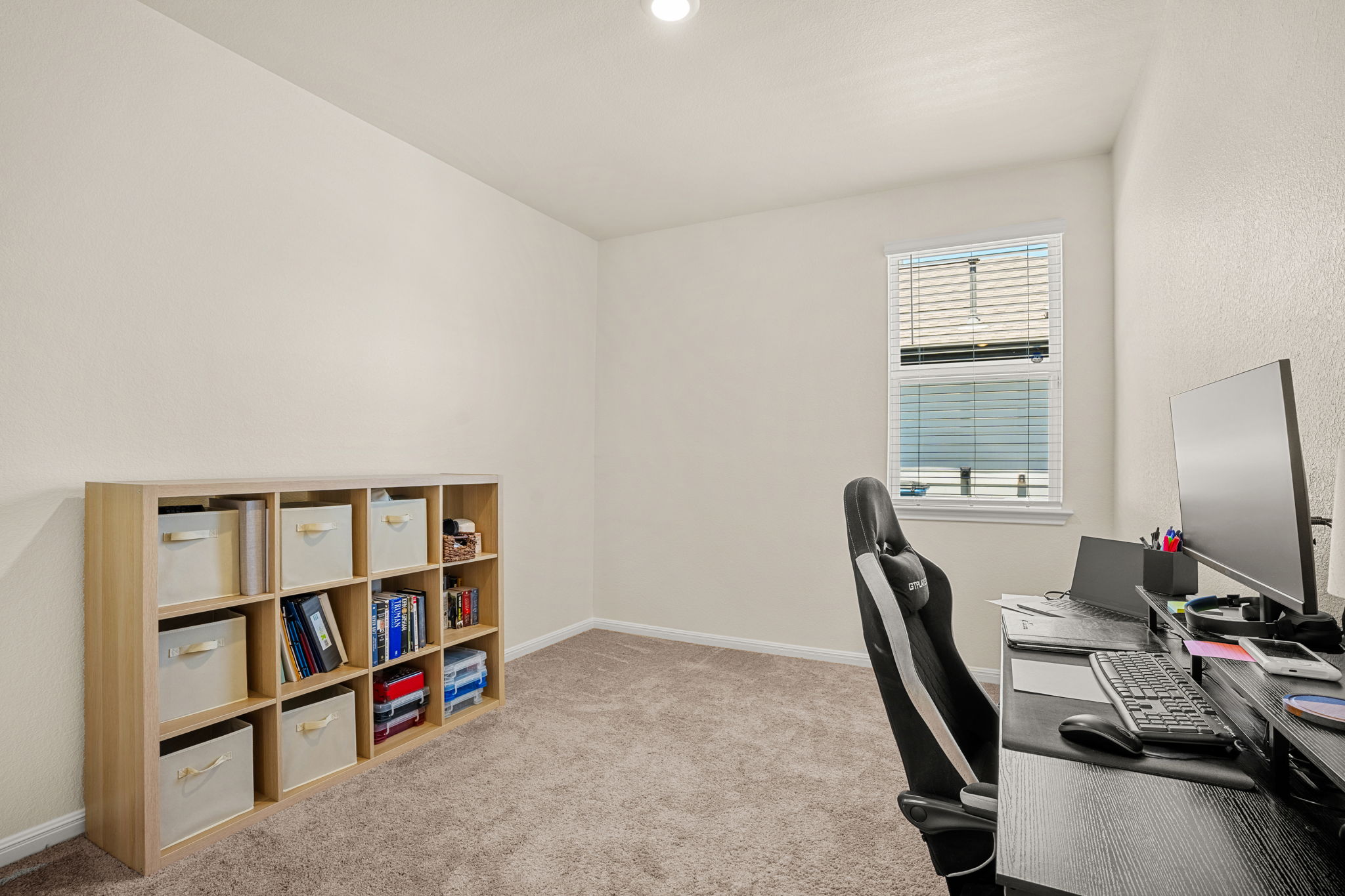 148 Hidalgo Lane Elgin, TX 78621 - Photo 18 of 38 A well-lit room offers a versatile space for an office or study.