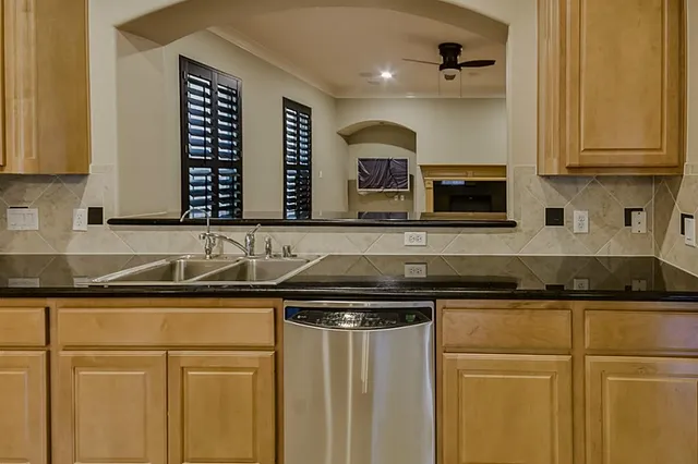 a kitchen with granite countertop cabinets stainless steel appliances and a sink
