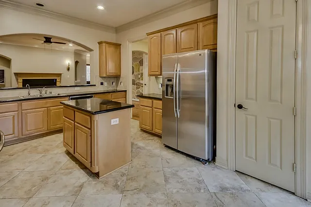 a kitchen with granite countertop a sink and cabinets