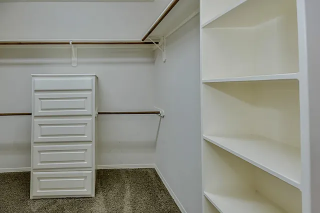 a bathroom with a granite countertop sink a mirror and a shower
