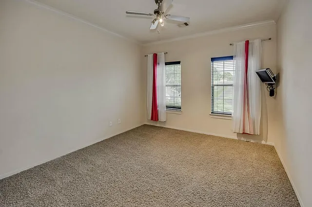 a view of walk in closet with empty racks