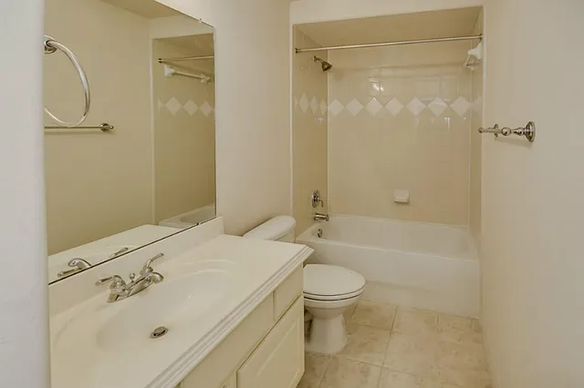 an empty room with a ceiling fan and a window