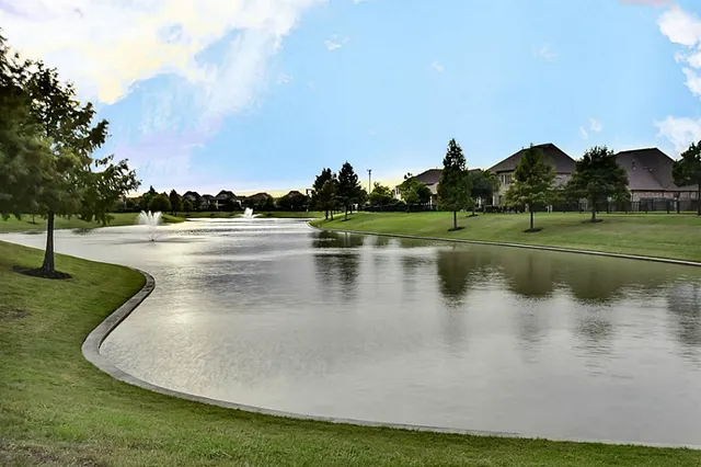 a view of a lake with houses in the back