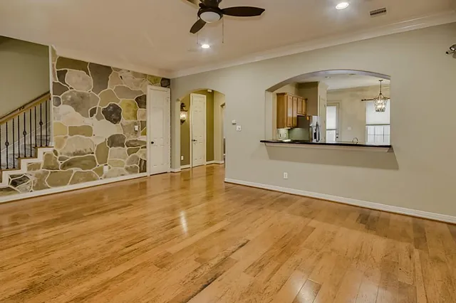 a view of an empty room with window and fireplace