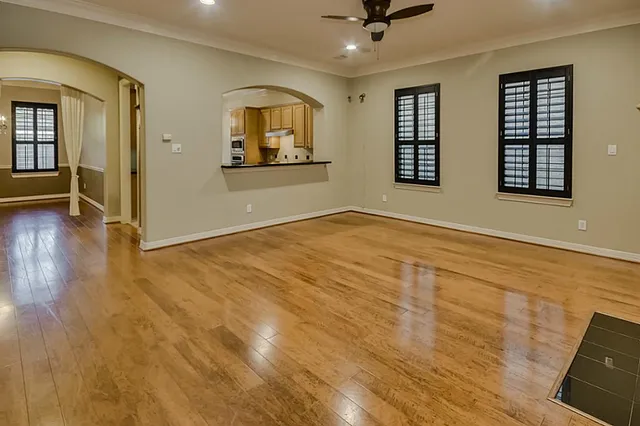 wooden floor in an empty room with a window