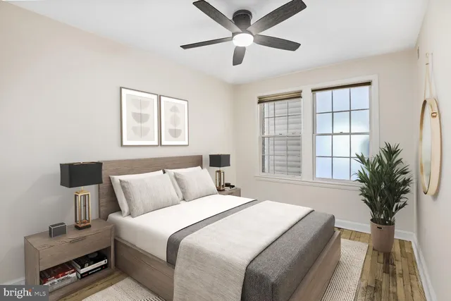 a bedroom with furniture and a large window