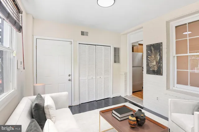 a living room with furniture and next to a window