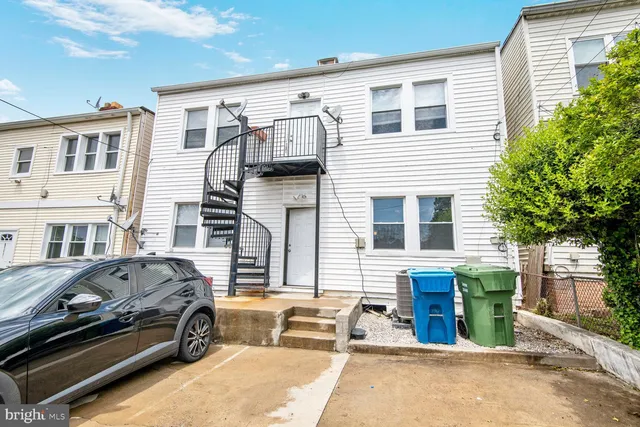 a front view of a house with parking space