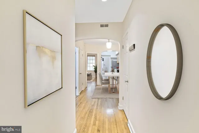 a view of a living room and bathroom with a mirror
