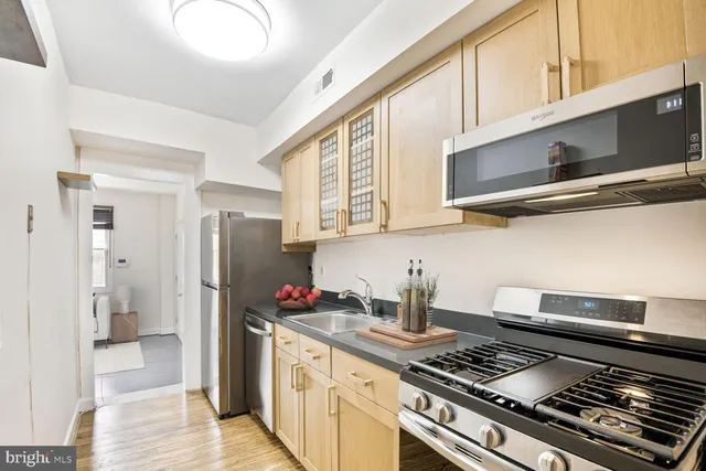 a kitchen with stainless steel appliances granite countertop a stove and a refrigerator