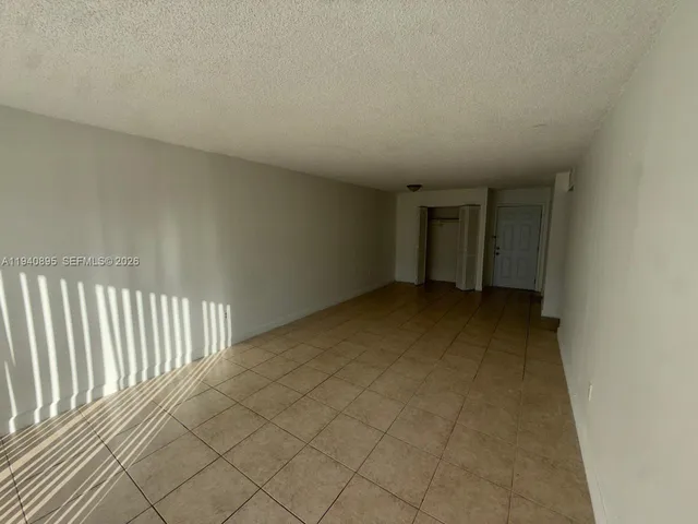a kitchen with a refrigerator sink and cabinets