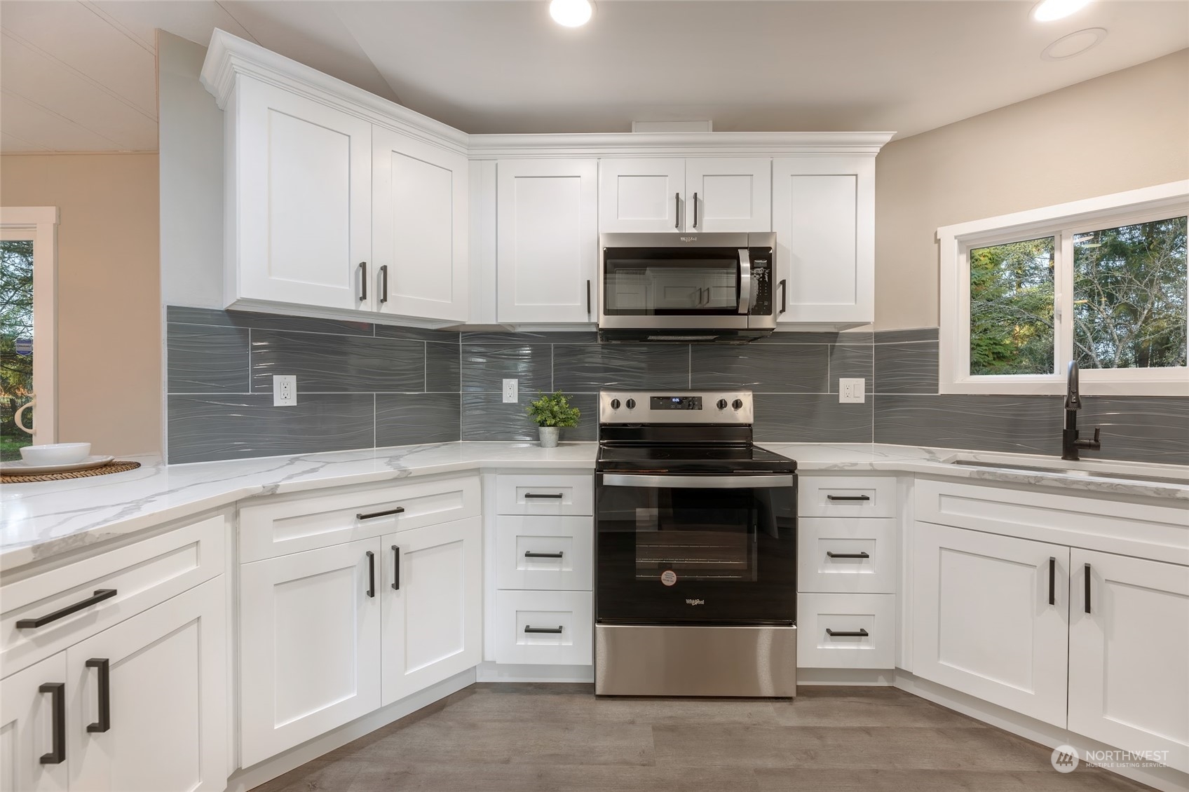 7020 187th Avenue Southwest Rochester, WA 98579 - Photo 26 of 40 a kitchen with white cabinets and stainless steel appliances