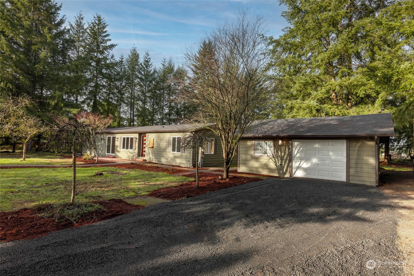 7020 187th Avenue Southwest Rochester, WA 98579 - Photo 4 of 40 a front view of a house with a yard