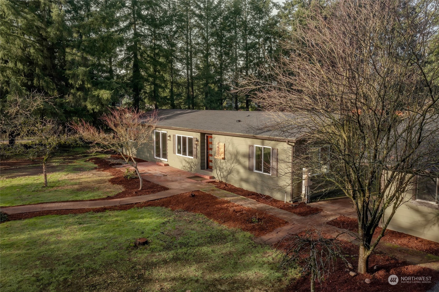 7020 187th Avenue Southwest Rochester, WA 98579 - Photo 6 of 40 a view of a yard in front of a house with large tree