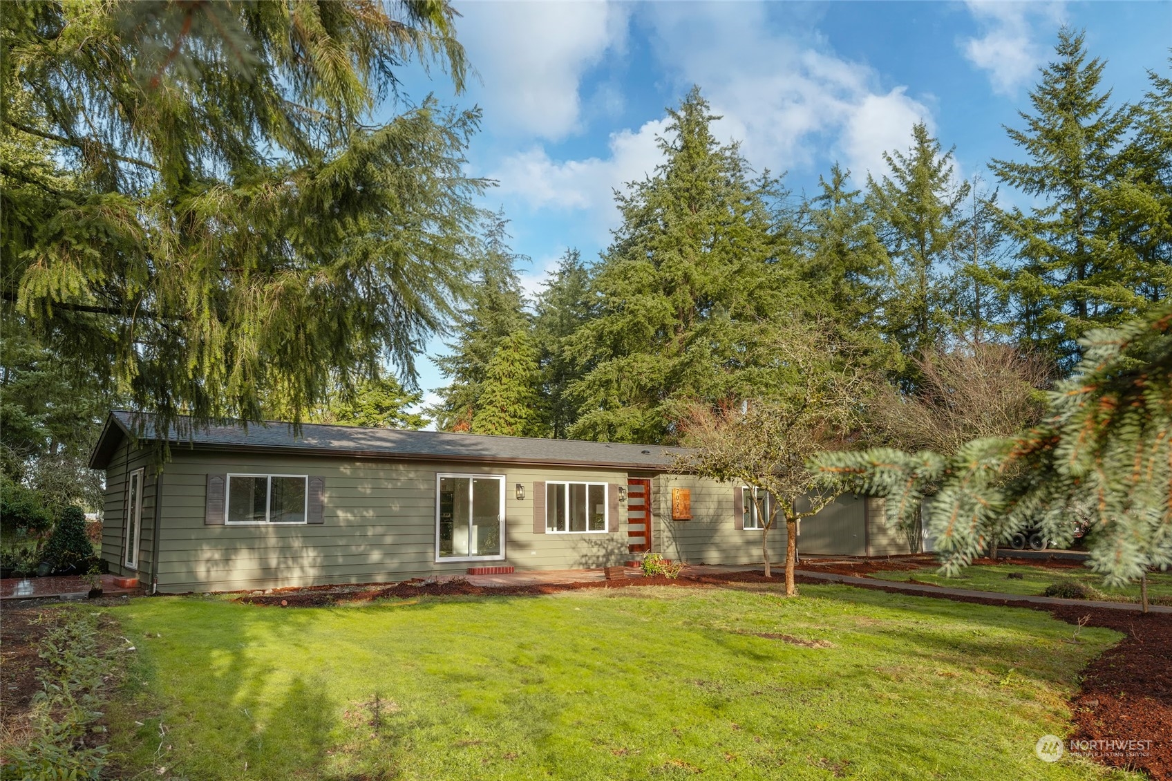 7020 187th Avenue Southwest Rochester, WA 98579 - Photo 8 of 40 a front view of a house with a garden